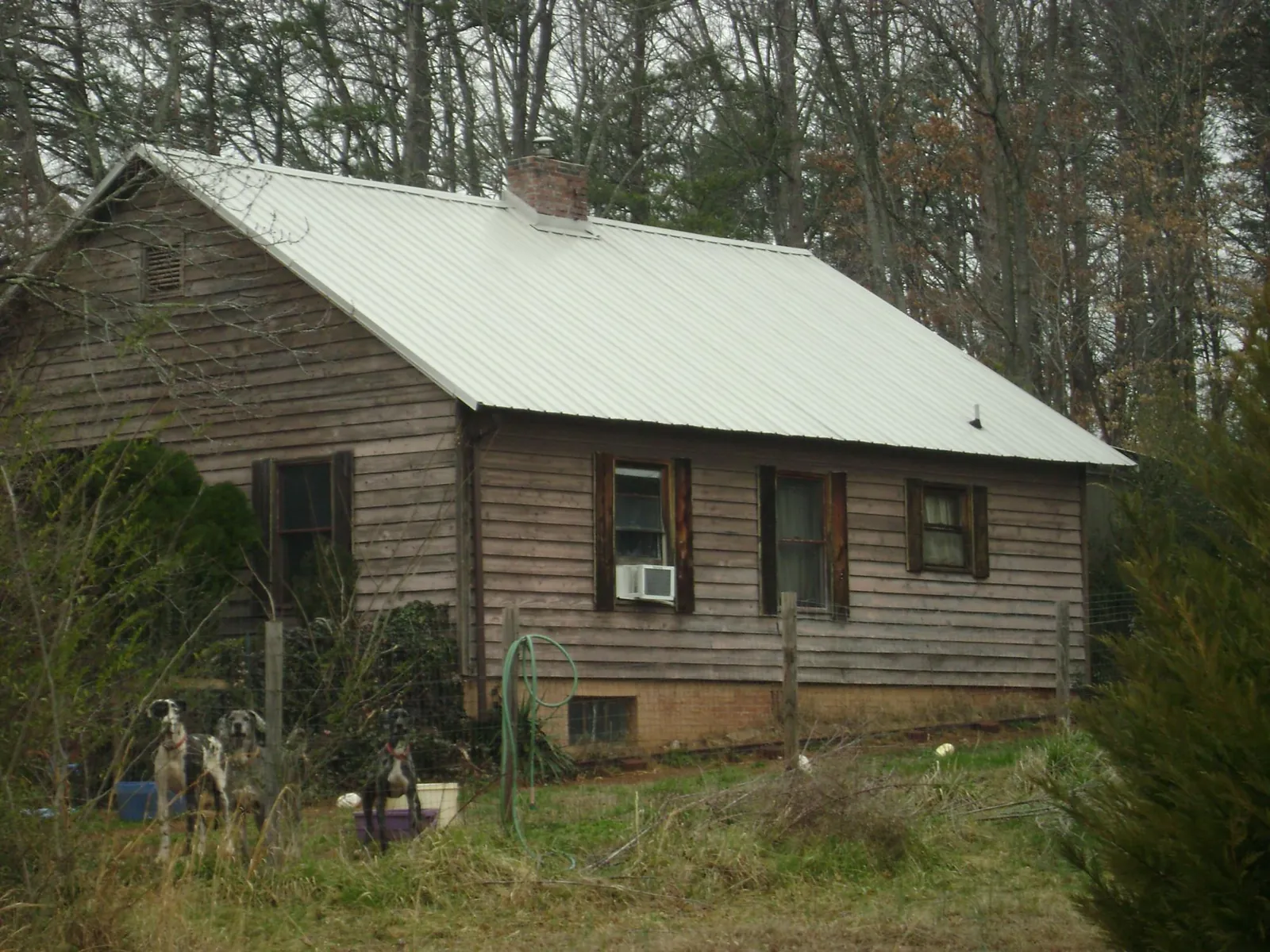 White metal roof on an old wood sided farmhouse, from a Metal Roof Installation job in Broadview Heights